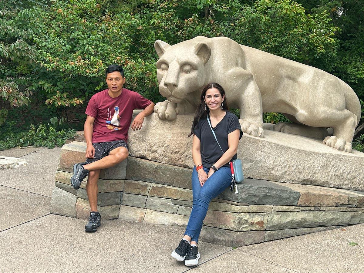 Photo of Belen and Geovanni in front of Nittany Lion Shrine